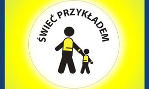 Baner promujący akcję świeć przykładem - na żółtym tle widoczne dwie postacie ludzi w kamizelkach odblaskowych trzymają się za ręce