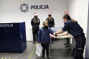 Policjantka wręcza dziecku prezenty