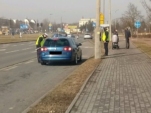 Policjant rozmawia z zatrzymanym  kierowcą do kontroli
