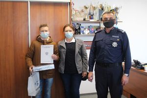 komendant z chłopcem i jego mamą pozują do zdjęcia