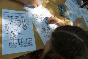 dzieci rysują na kartkach policjanta