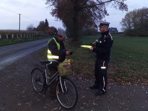 policjant daje mężczyźnie kamizelkę