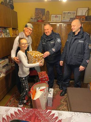 policjanci wręczają paczki dziewczynce